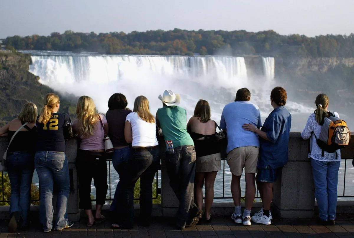 Tourists look out at Niagara Falls from the Canadian side of the Canada/U.S. border in a file photo. (Don Emmert/AFP/Getty Images)