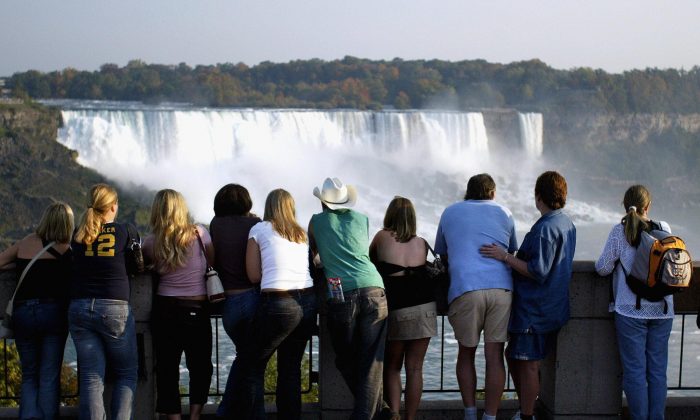 Tourists look out at Niagara Falls from the Canadian side of the Canada/U.S. border. Canada is halting efforts to attract U.S. tourists after years of largely failing to draw Americans from other leisure destinations. (Don Emmert/AFP/Getty Images) 
