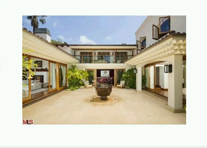 A screenshot of Realtor.com shows the mansion.