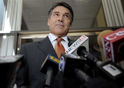 A file photo of Texas Gov. Rick Perry speaking to the media before hosting a lunch appointment with Connecticut gun makers in Hartford, Conn., Monday, June 17, 2013.  Perry celebrated the Supreme Court's decision on June 25 to strike down part of the Voting Rights Act that restricted Texas's autonomy in deciding its voting laws. (AP Photo/Jessica Hill)