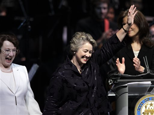 In this Monday, Jan. 4, 2010 file photo, Houston Mayor Annise Parker, center, walks onto the stage with her partner, Kathy Hubbard, during a public inauguration ceremony in Houston. Houston is the largest U.S. city to elect an openly gay mayor. (AP Photo/David J. Phillip)
