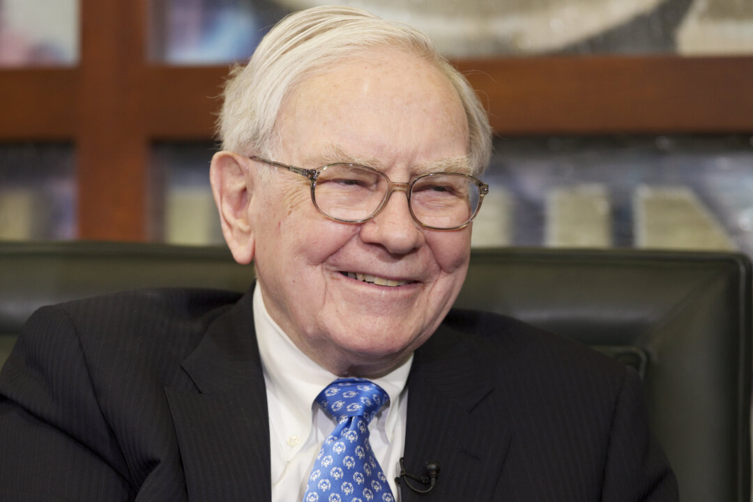 In this May 6, 2013 photo, Warren Buffett smiles during a television interview in Omaha, Neb. The annual charity auction of a private lunch with billionaire investor Warren Buffett has entered its final hours with the rare opportunity still available for the relative bargain price of less than a million dollars. (AP Photo/Nati Harnik)