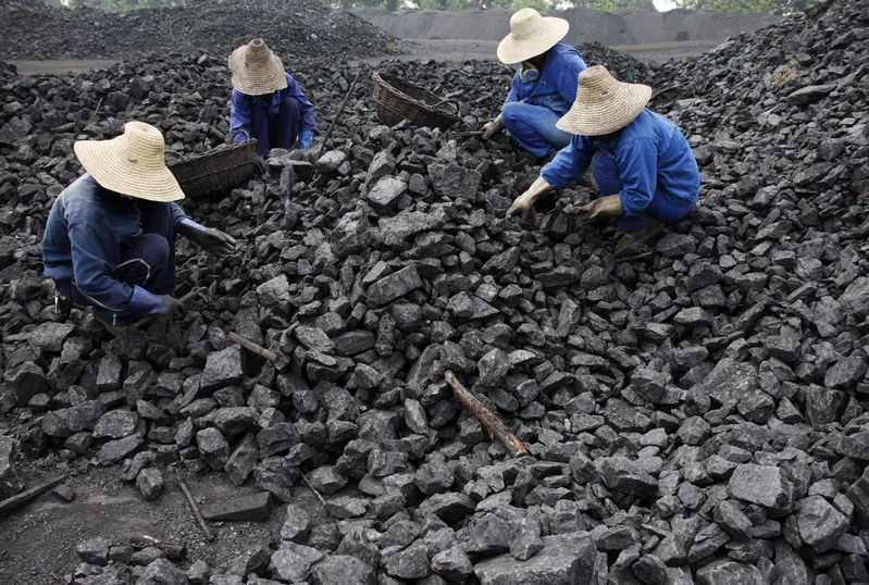 Chinese miners process coal from a mine in Huaibei, east China's Anhui province on July 13, 2010. (STR/AFP/Getty Images) 