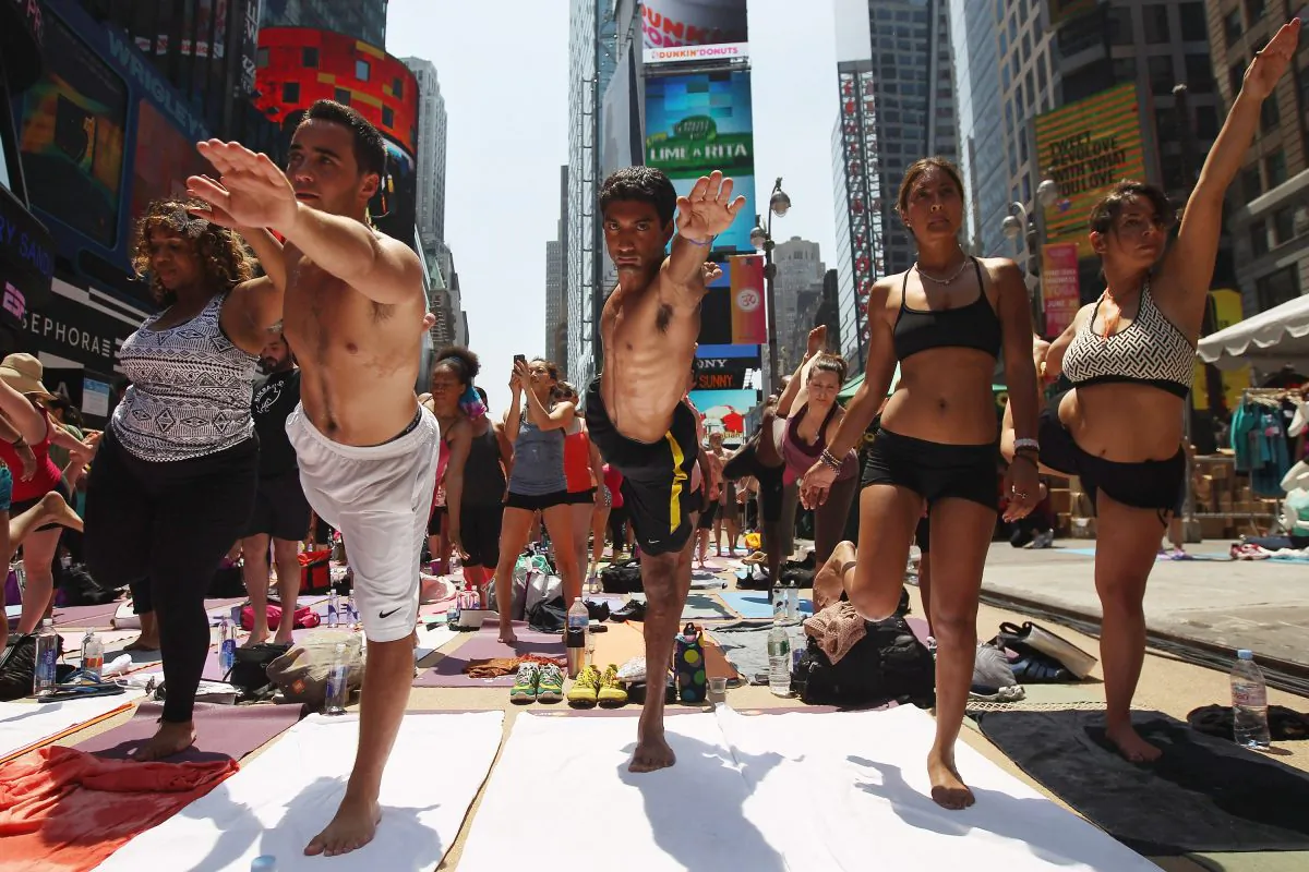 NEW YORK, NY-People brave high temperatures while practicing bikram yoga as part of the annual Mind Over Madness event in Times Square on June 20, 2012 in New York City. (John Moore/Getty Images)