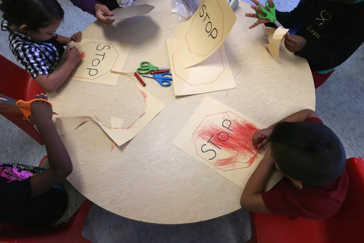 Children from low-income families draw at the federally funded Head Start school on Sept. 20, 2012, in Woodbourne, N.Y. Poor and low-income children are less safe than their affluent peers, according to a new report. (John Moore/Getty Images)