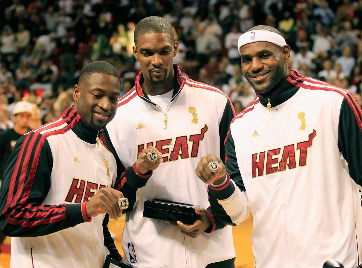 Miami Heat "Big 3", (L) Dwyane Wade #3 of the Miami Heat, (C) Chris Bosh #1 of the Miami Heat and (R) LeBron James #6 of the Miami Heat pose with their 2012 NBA Championship rings on Oct. 30, 2012 in Miami, Florida. (Chris Trotman/Getty Images) 
