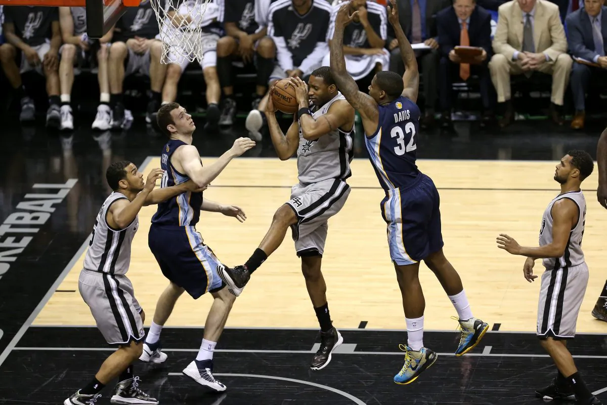 Tracy McGrady #1 of the San Antonio Spurs grabs a rebound against Ed Davis #32 of the Memphis Grizzlies during Game One of the Western Conference Finals of the 2013 NBA Playoffs at AT&T Center on May 19, 2013 in San Antonio, Texas. (Stephen Dunn/Getty Images)
