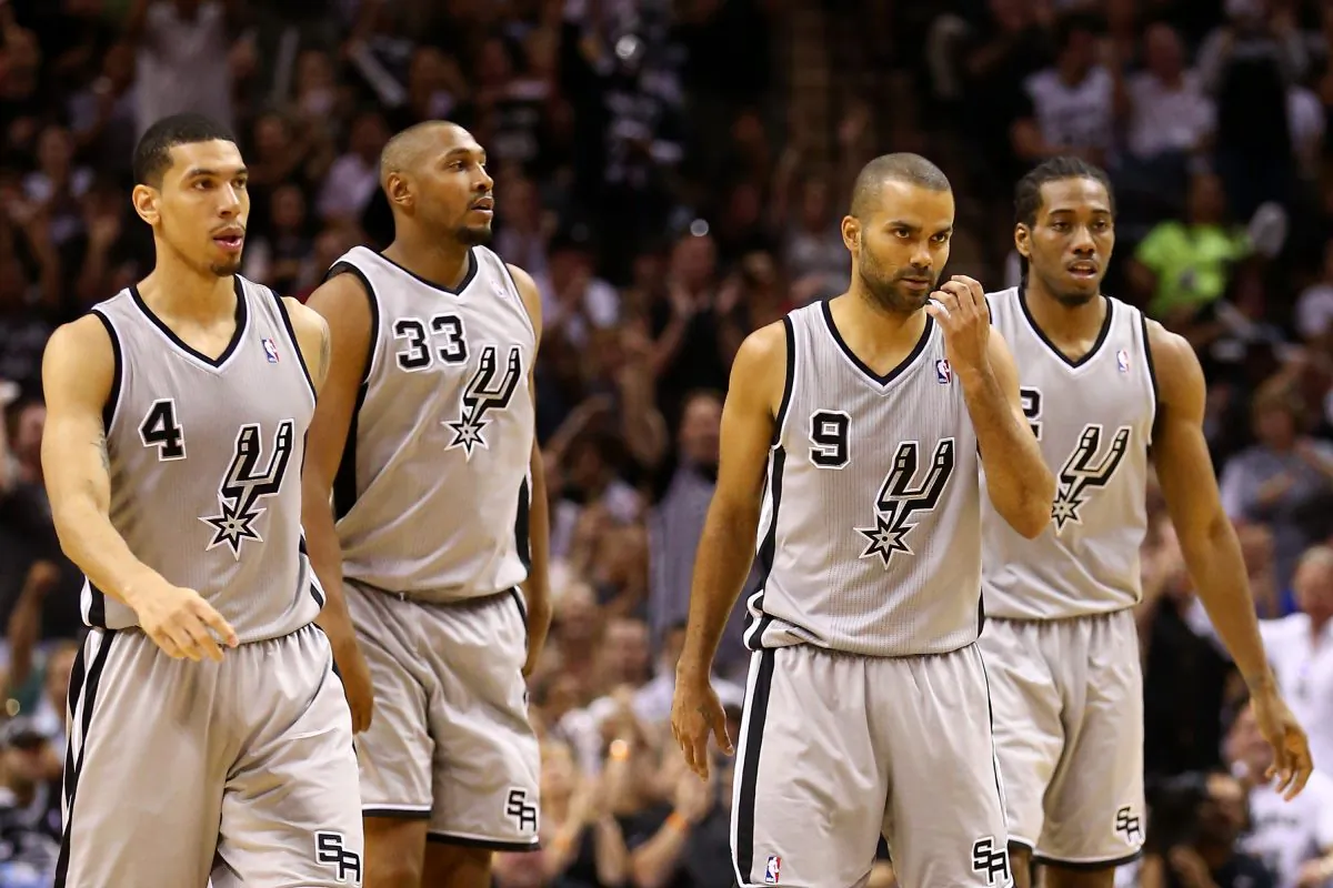 Danny Green (Left, 25 years old) and Kawhi Leonard (Right, 21 years old), both starters and pictured here with two older teammates (Boris Diaw, #33 and 31 years old) and Tony Parker (31 years old) are two reasons the San Antonio Spurs are on average younger than the Miami Heat. (Ronald Martinez/Getty Images)