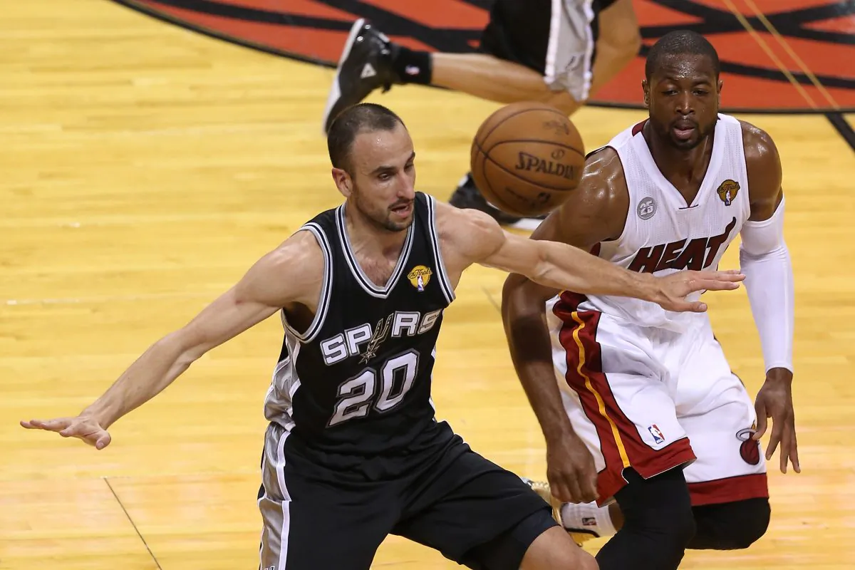Manu Ginobili #20 of the San Antonio Spurs and Dwyane Wade #3 of the Miami Heat go after a loose ball in the second quarter during Game One of the 2013 NBA Finals at AmericanAirlines Arena on June 6, 2013 in Miami, Florida. (Christian Petersen/Getty Images)