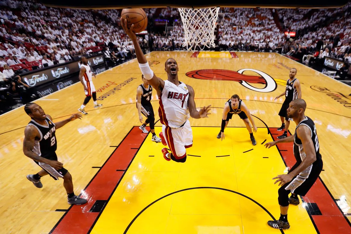 MIAMI, FL - JUNE 06: Chris Bosh #1 of the Miami Heat goes up for a shot in the lane between Kawhi Leonard #2 and Tim Duncan #21 of the San Antonio Spurs in the third quarter during Game One of the 2013 NBA Finals at AmericanAirlines Arena on June 6, 2013 in Miami, Florida. (Photo by Mike Ehrmann/Getty Images)