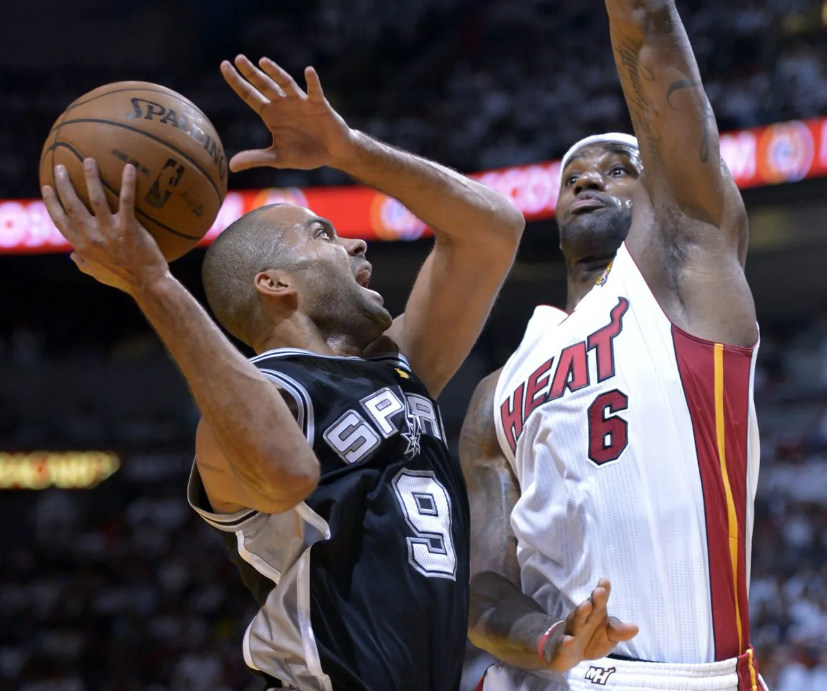 Tony Parker (L) of the San Antonio Spurs goes to the basket against LeBron James (R) of the Miami Heat in the first half during Game 1 of the NBA Finals on June 6, 2013 at American Airlines Arena in Miami, Florida. (AFP PHOTO / Brendan SMIALOWSKI)