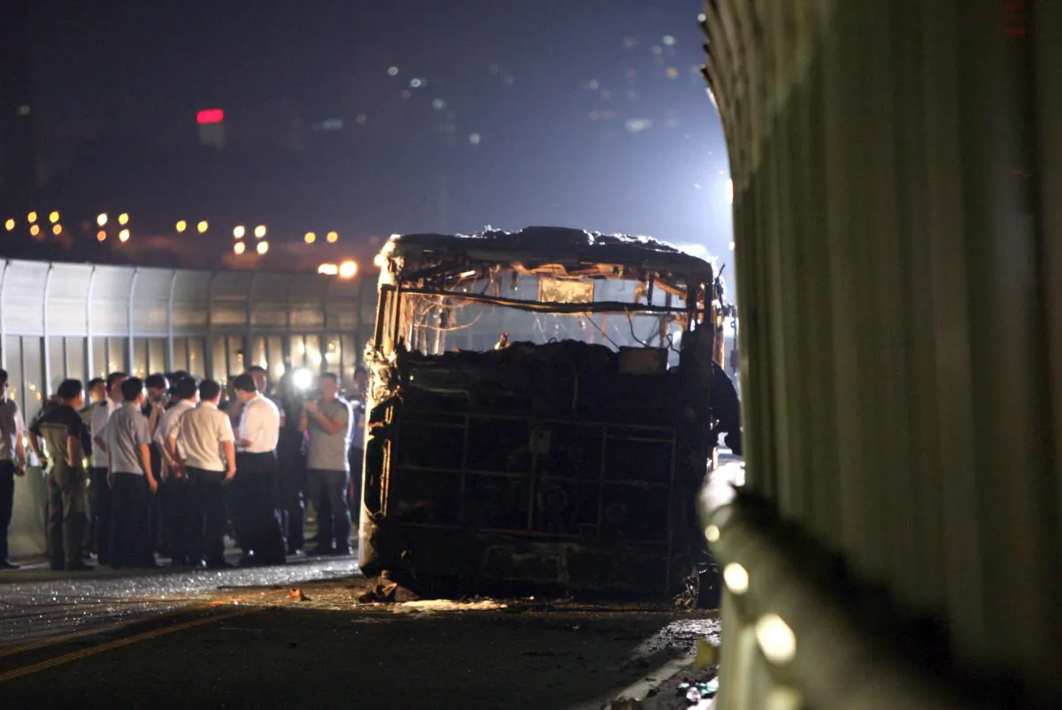 This picture taken on June 7, 2013 shows investigators at the scene of a bus that caught fire on the BRT (Bus Rapid Transit) elevated road in the city of Xiamen, China's southeast Fujian province. A fire that engulfed a commuter bus in minutes during rush hour in the Chinese city of Xiamen, killing 47 and injuring dozens more, appears to have been deliberately set, state media quoted investigators as saying on June 8. (STR/AFP/Getty Images)