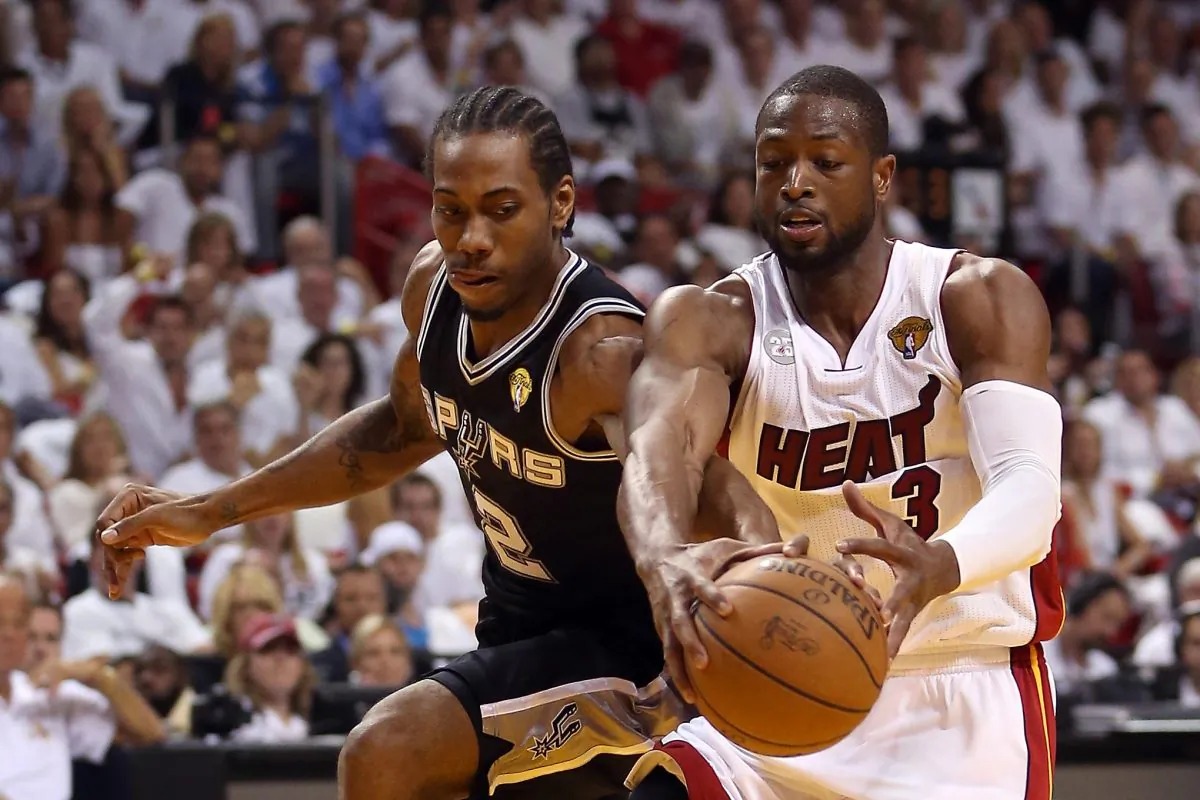 Dwyane Wade #3 of the Miami Heat with the ball against Kawhi Leonard #2 of the San Antonio Spurs in the first quarter during Game Two of the 2013 NBA Finals at AmericanAirlines Arena on June 9, 2013 in Miami, Florida. (Christian Petersen/Getty Images)