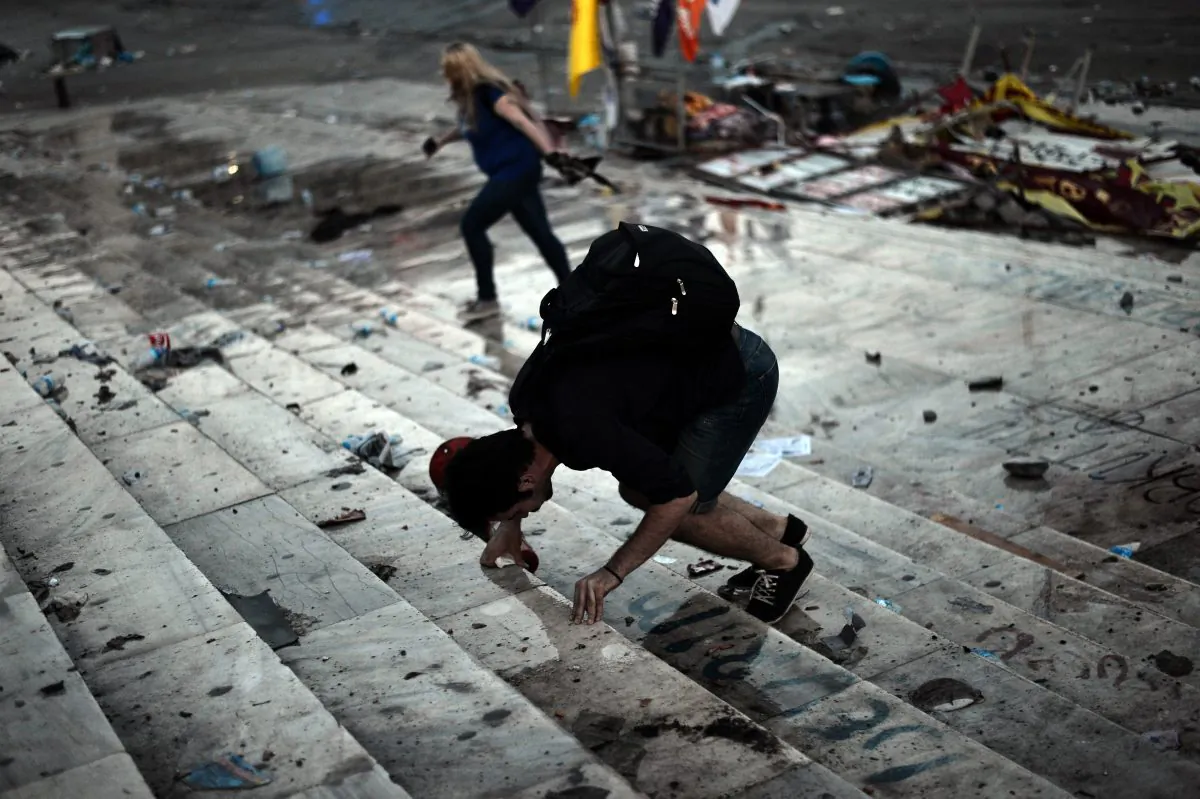 A protester reacts to tear gas during clashes at Taksim square in Istanbul on June 11, 2013. Riot police fired tear gas and rubber bullets to clear protesters from the square as Turkish Prime Minister Recep Tayyip Erdogan warned he would show 'no more tolerance' for the unrelenting mass demonstrations against his government. (Aris Messinis/AFP/Getty Images) 