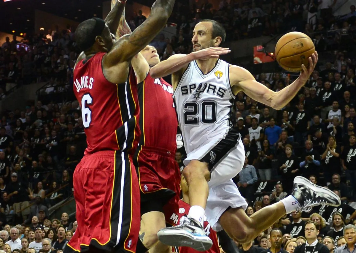 Manu Ginobili (R) of the San Antonio Spurs looks to pass under pressure from LeBron James (L) and Chris Andersen of the Miami Heat during game three of the NBA Finals on June 11, 2013 in San Antonio, Texas. (Frederic J. Brown/AFP/Getty Images)