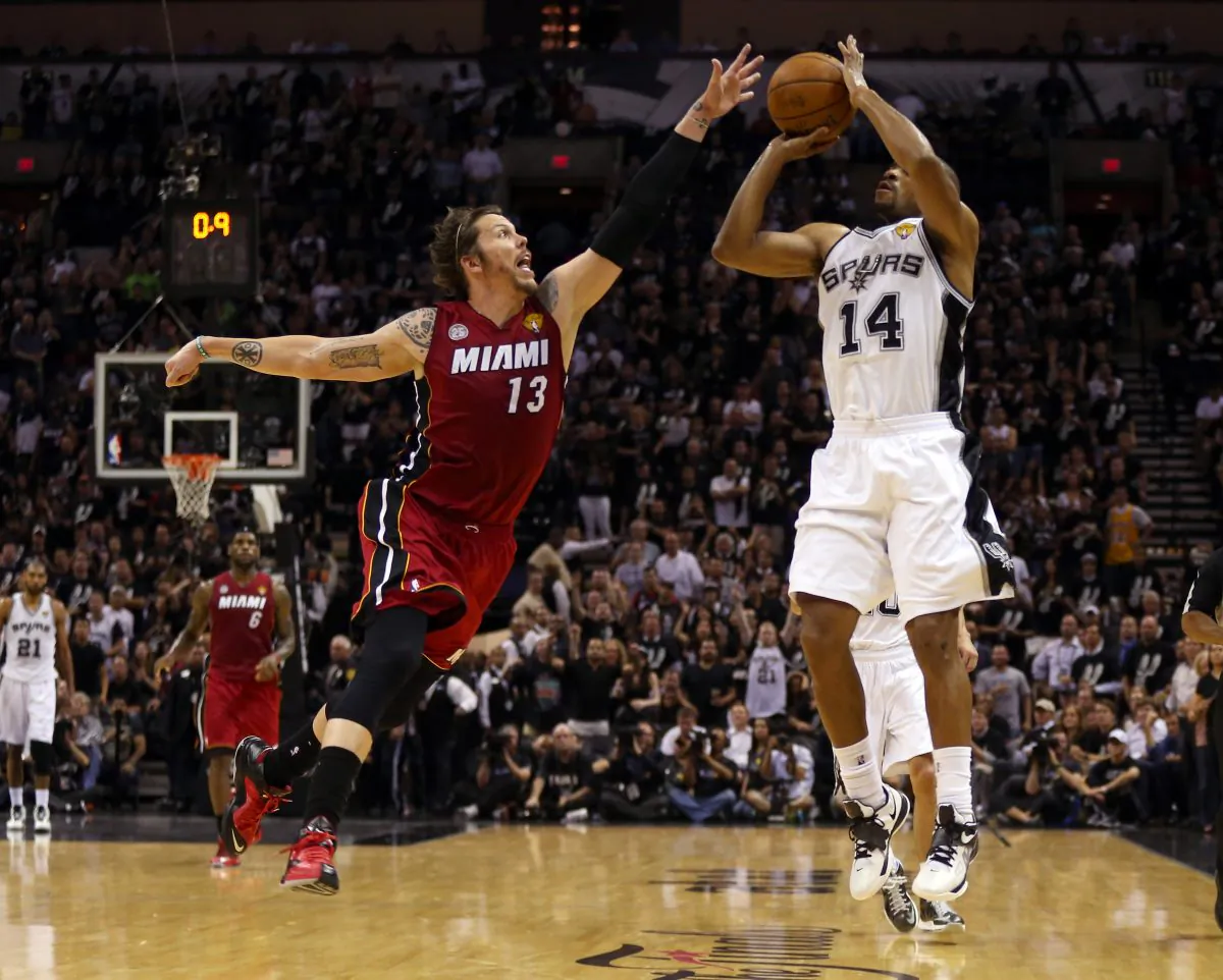 Gary Neal #14 of the San Antonio Spurs makes a three pointer over Mike Miller #13 of the Miami Heat to end the second quarter during Game Three of the 2013 NBA Finals at the AT&T Center on June 11, 2013 in San Antonio, Texas. (Mike Ehrmann/Getty Images)