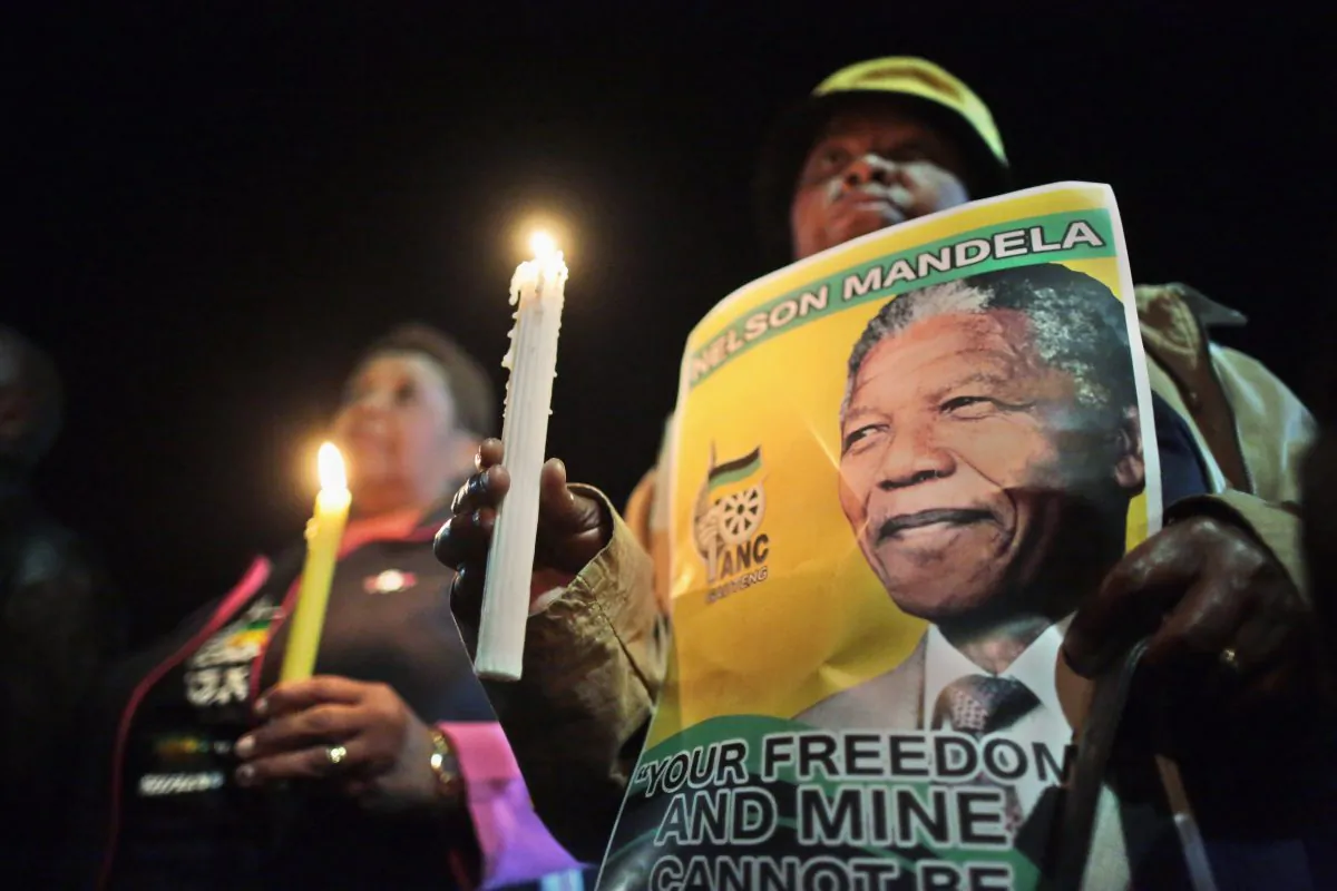 Supporters hold a candlelit vigil outside the former home of former South African President Nelson Mandela in Soweto township on June 27, 2013 in Johannesburg, South Africa. South African President Jacob Zuma confirmed on June 23 that Mandela's condition has become critical since he was admitted to the hospital over two weeks ago for a recurring lung infection. (Christopher Furlong/Getty Images)