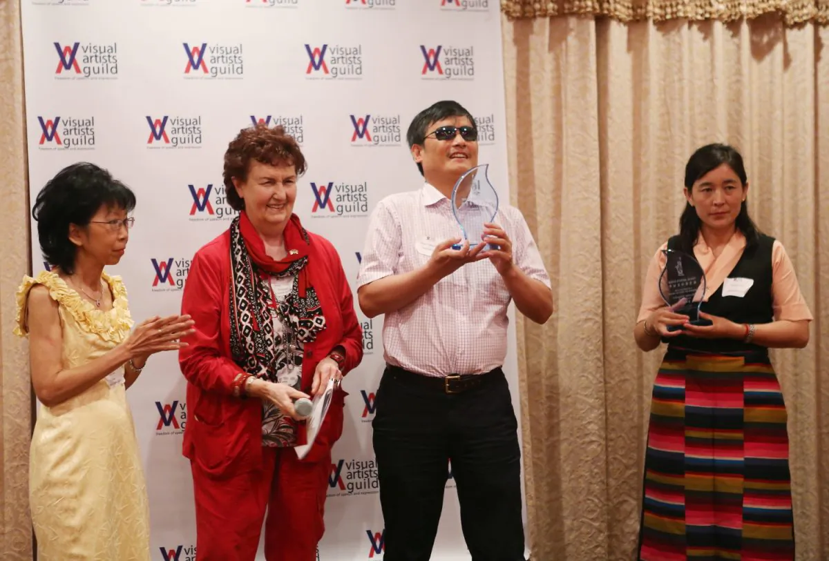(L–R) Ann Lau, chair of Visual Arts Guild (VAG), Peggy Howards Chane, president of VAG, Chen Guangchen and Lhamo Tso, on behalf of her husband Dhondup Wangchen, receive Visual Artist Guild NYC Freedom of Speech Award, New York, June 1, 2013. (Gary Du/The Epoch Times)