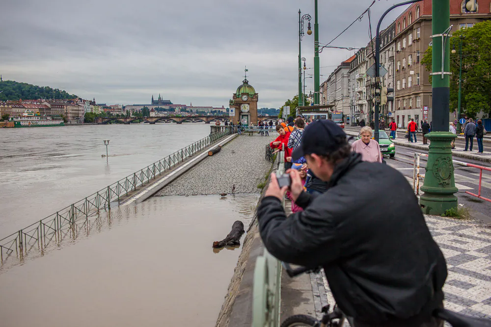  A man takes a picture of the flooded Vltava River, Prague, Czech Republic, June 3, 2013. (Petr Svab/Epoch Times)