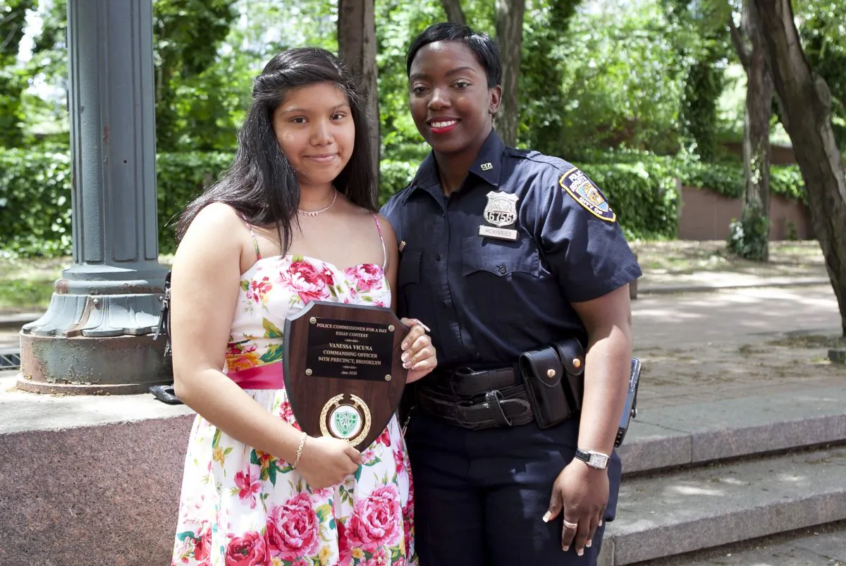 Police Officer Shantel McKinnes and essay contest winner Vanessa Vicuna outside of NYC Police Headquarters on June 5. (Samira Bouaou/The Epoch Times)