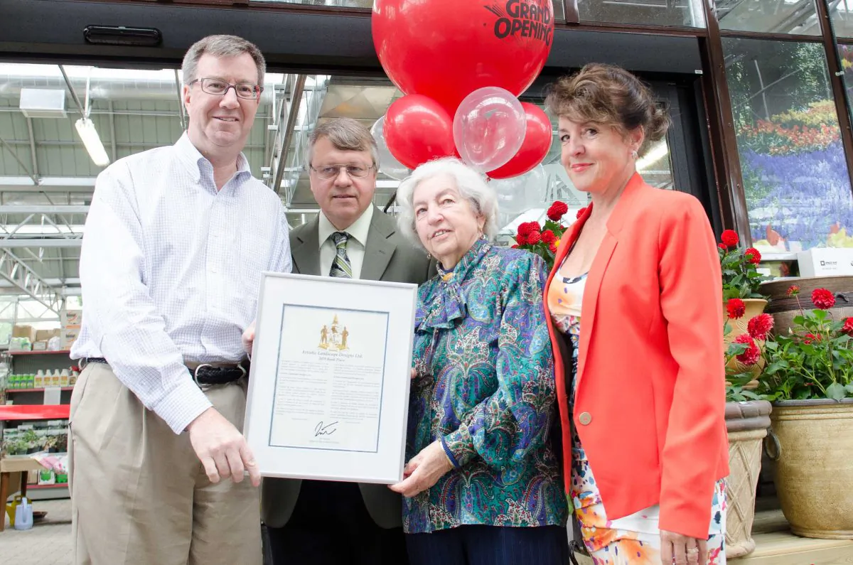 Ottawa Mayor Jim Watson poses with the Schmitz family after honouring them with a congratulatory plaque from city council on June 8, 2013, for the recent new developments of their business, Artistic Landscape Designs. L-R: Mayor Jim Watson, Eckhart Schmitz, Edeltrut Schmitz, and Eva Schmitz. (Matthew Little/The Epoch Times)
