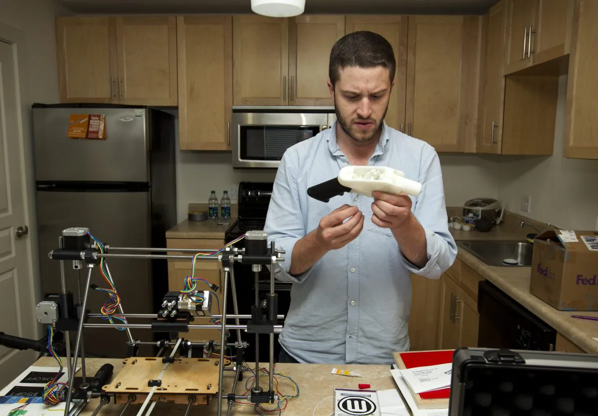 Cody Wilson works on the first completely 3D-printed handgun, The Liberator, at his home in Austin on Friday May 10, 2013. (Austin American Statesman, Jay Janner/AP Photo) 