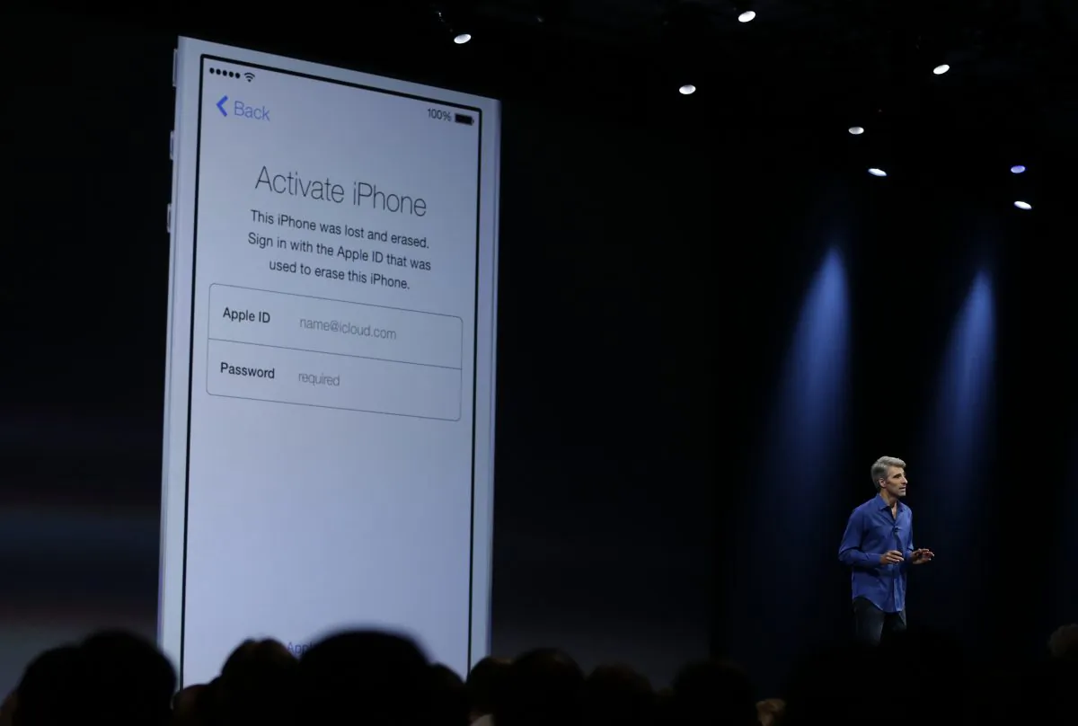 Craig Federighi, senior vice president of Software Engineering at Apple demonstrates the new activation lock security feature in iOS 7 during the keynote address of the Apple Worldwide Developers Conference Monday, June 10, 2013 in San Francisco. (AP Photo/Eric Risberg)