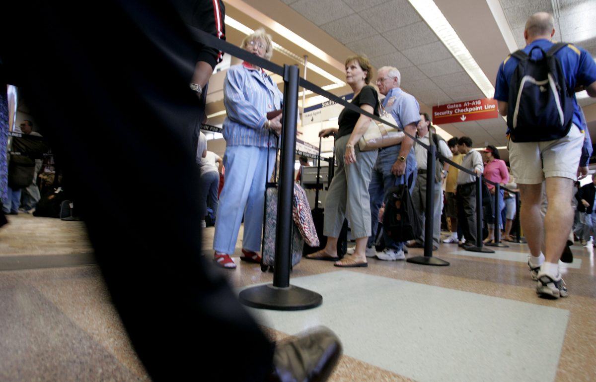 Airline passengers wait in a long line at a security checkpoint at San Jose International Airport in San Jose, Calif. in this file photo. (AP Photo/Paul Sakuma)