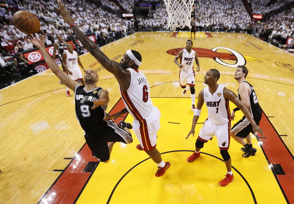 San Antonio Spurs point guard Tony Parker (9) heads to the hoop as Miami Heat small forward LeBron James (6) defends during the first half of Game 1 of basketball's NBA Finals, Thursday, June 6, 2013 in Miami. (AP Photo/Mike Ehrmann, Pool)