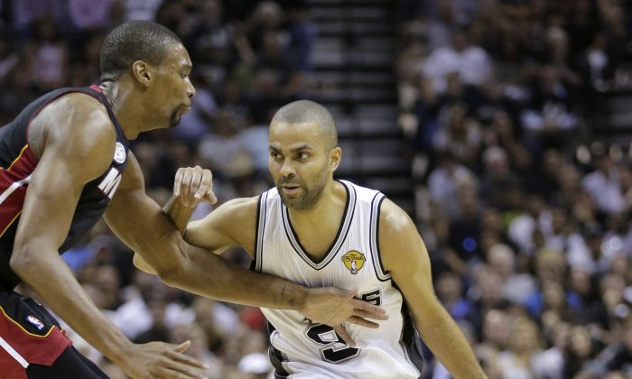 San Antonio Spurs' Tony Parker drives as Miami Heat's Chris Bosh defends during the first half at Game 4 of the NBA Finals basketball series, Thursday, June 13, 2013, in San Antonio. (AP Photo/Eric Gay)
