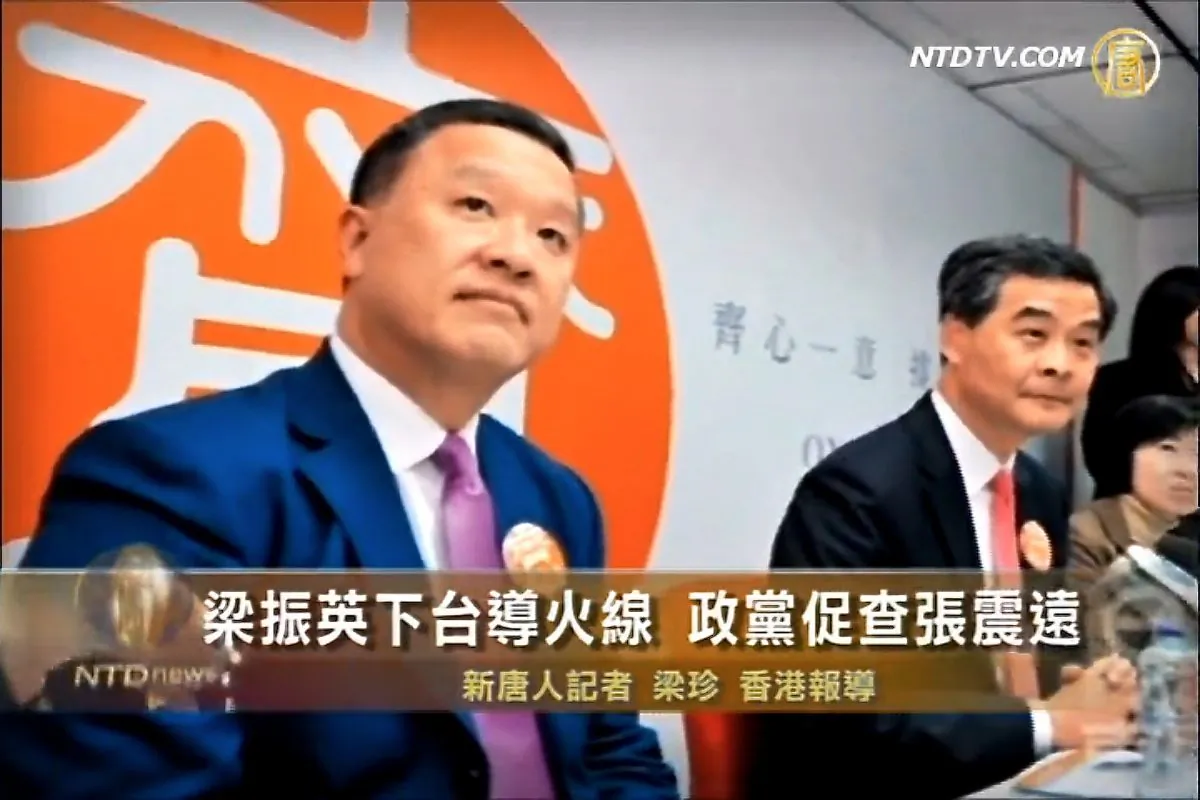 Barry Cheung (L) is pictured alongside his former boss, Hong Kong Chief Executive Leung Chun-ying. Cheung is in trouble now that an exchange he ran is being investigated for financial irregularities; the arrest of a number of people from mainland China, carrying falsified financial documents worth hundreds of millions of dollars, have added to the intrigue. (NTD screenshot via The Epoch Times)