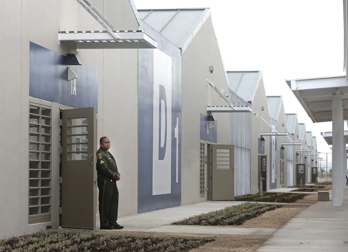 A correctional officer stands outside of one of the secure housing units at the new California Correctional Health Care Facility in Stockton, Calif., June 25, 2013. The facility, which is expected to begin receiving inmates in July, will treat up to 1,720 inmate-patients in need of long-term care, freeing up staff and treatment space at the state's 33 adult prisons. (AP Photo/Rich Pedroncelli)