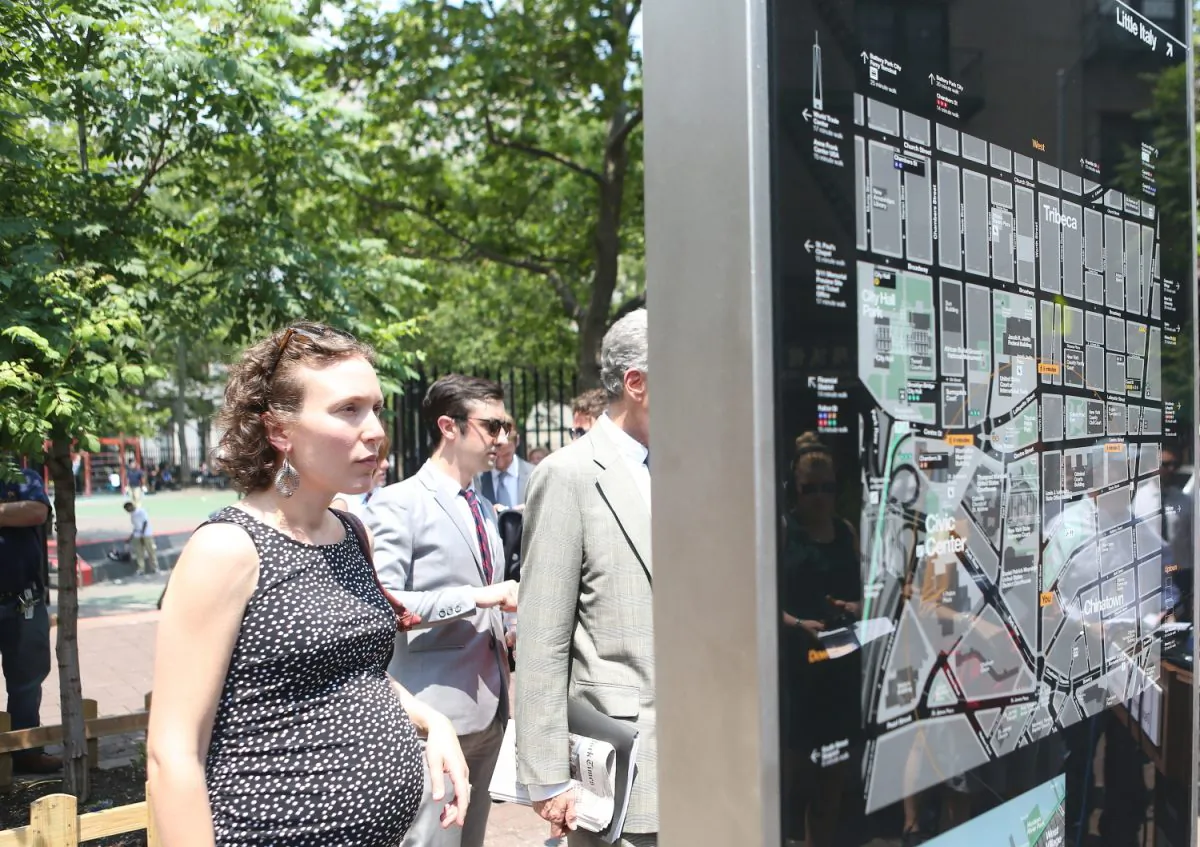 A woman views a WalkNYC pedestrian map in Manhattan’s Chinatown on June 24, 2013. (Gary Du/Epoch Times)
