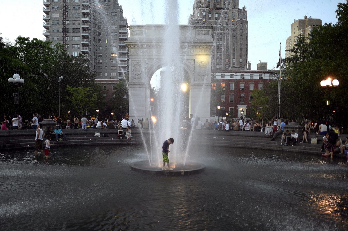 FOUNTAIN OF COOL: Kids takes advantage of the hot weather as they play in the fountain at dusk at Washington Square Park May 31, 2013 as temperatures reach in the 90's in New York City. (Timothy Clary/AFP/Getty Images)