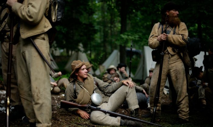 Members of the 1st Tennessee wait to take part in in a demonstration of a battle during ongoing activities commemorating the 150th anniversary of the Battle of Gettysburg, Friday, June 28, 2013, at Bushey Farm in Gettysburg, Pa. Union forces turned away a Confederate advance in the pivotal battle of the Civil War fought July 1-3, 1863, which was also the war’s bloodiest conflict with more than 51,000 casualties. (AP Photo/Matt Rourke) 