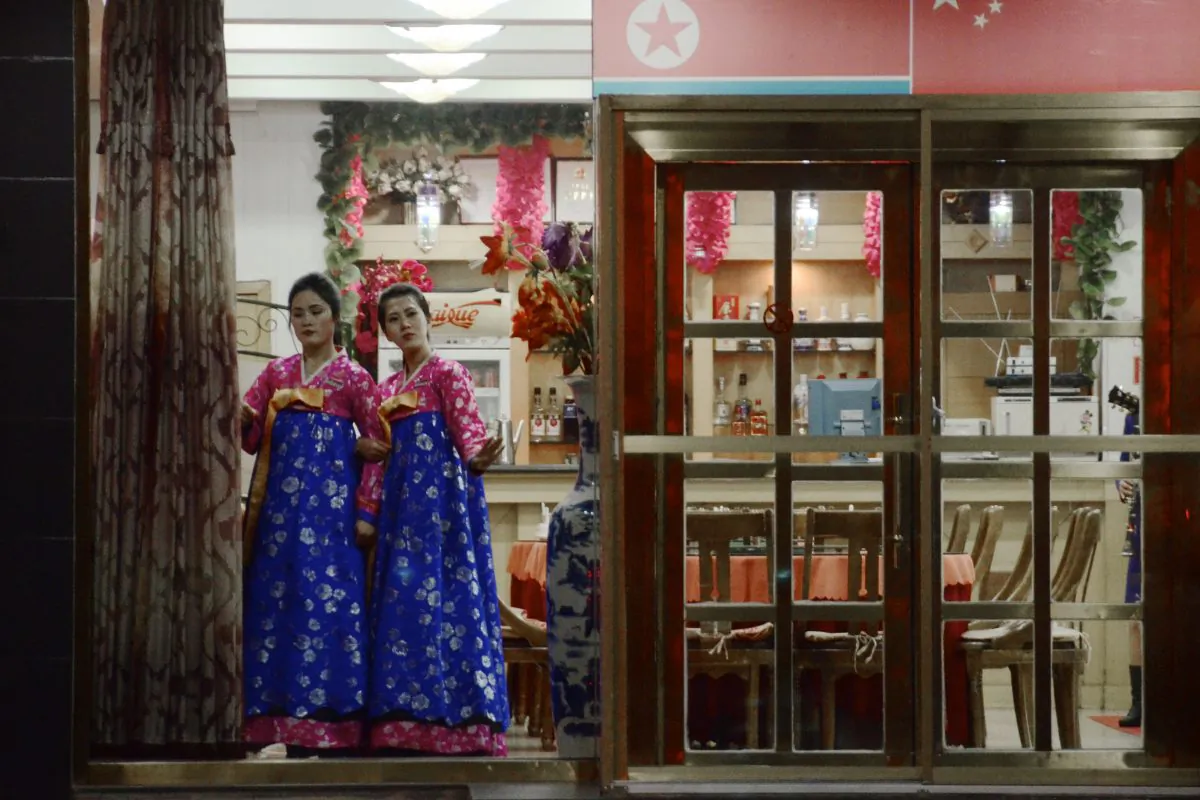 Hostesses wait for customers at the entrance to a Korean restaurant in Dandong in China's northeastern Liaoning Province, on Dec. 12, 2012. Growth in China's restaurant industry slowed by almost 40 percent in 2012. (Wang Zhao/AFP/Getty Images) 