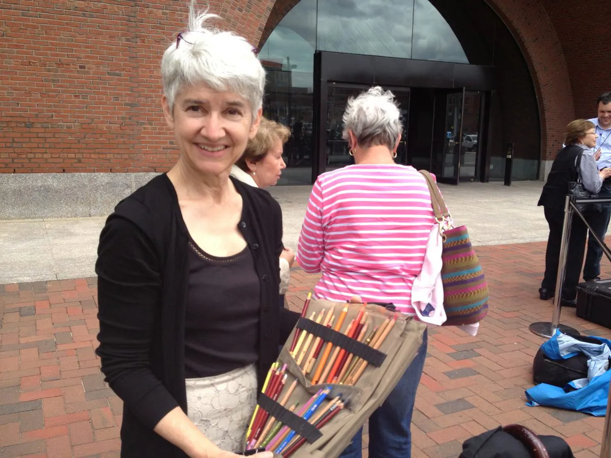 Courtroom sketch artist Margaret Small displays her pencils outside the John Joseph Moakley Courthouse in Boston Mass., after the close of the first day of the trial of Mafia boss James 'Whitey' Bulger, June 12. (Phoebe Ryles/The Epoch Times)