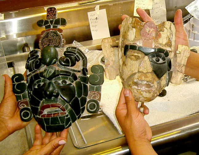 Pascual de Paz holds a replica of a Mayan tomb mask he is working on. Next to it is a finished model. (Courtesy of Myriam Moran)