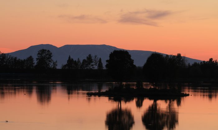 The sun sets over Westchester Lagoon just before 1 a.m. on Sunday, June 16, 2013, in Anchorage, Alaska. (Associated Press/Dan Joling)