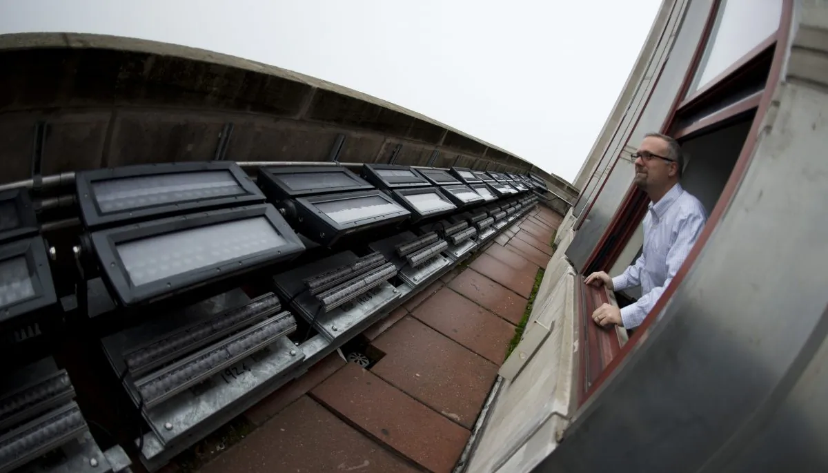 A file photo of Philips engineer Jeremy Day looking out a window on the 72nd floor of the Empire State Building at LED fixtures in New York on Jan. 16, 2013. New York engineering students may get a hand up with a state bill introduced June 5, 2013 that would forgive student loans for engineering students. (Don Emmert/AFP/Getty Images) 