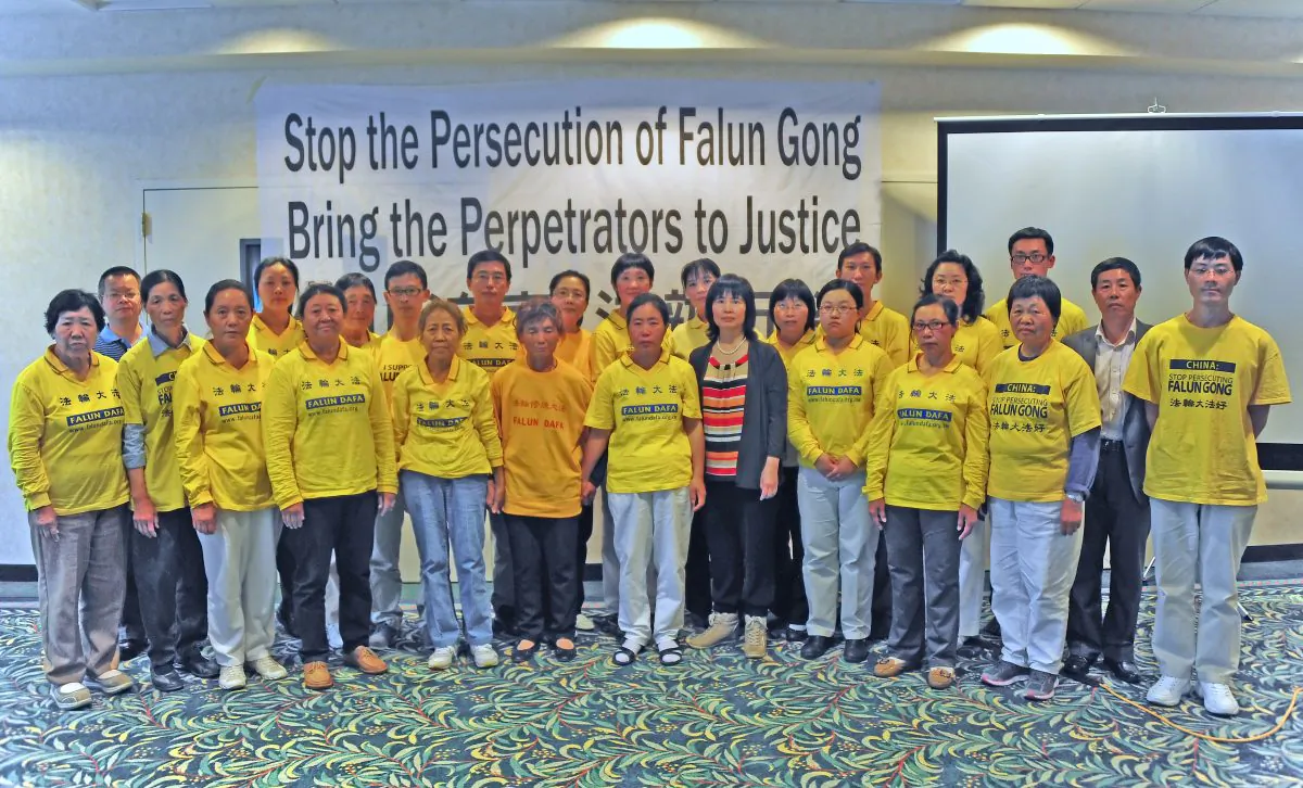 25 Falun Gong practitioners formerly held as prisoners of conscience at Chinese brainwashing labor camps and prisons, at a press conference at the Hilton Garden Inn in Rancho Mirage, CA on June 6, 2013. President Obama and Chinese Communist Party leader Xi Jinping will be in meetings June 7 and 8 in the same city. (Robin Kemker/The Epoch Times)