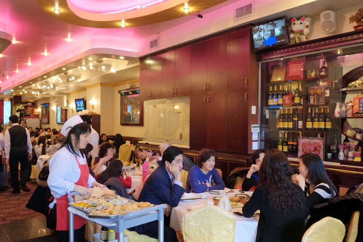 A waitress brings a cart of dim sum to a table of customers at a restaurant in the Chinatown neighborhood of New York, on Jan. 19, 2013. (Mark Lennihan/AP Photo)