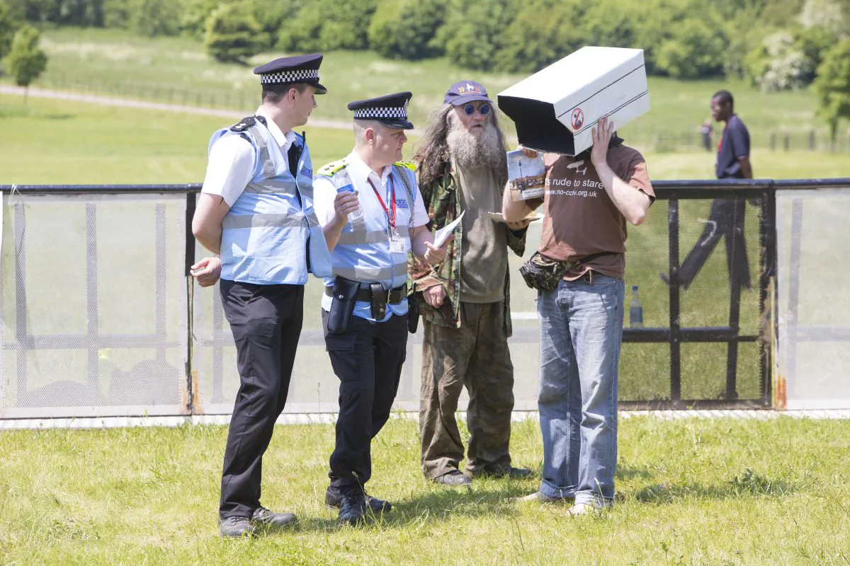 Protesters talk with police outside the steel fence set up around the 2013 Bilderberg Group meeting in London, on June 6, 2013. (Simon Gross/Ben Dome)