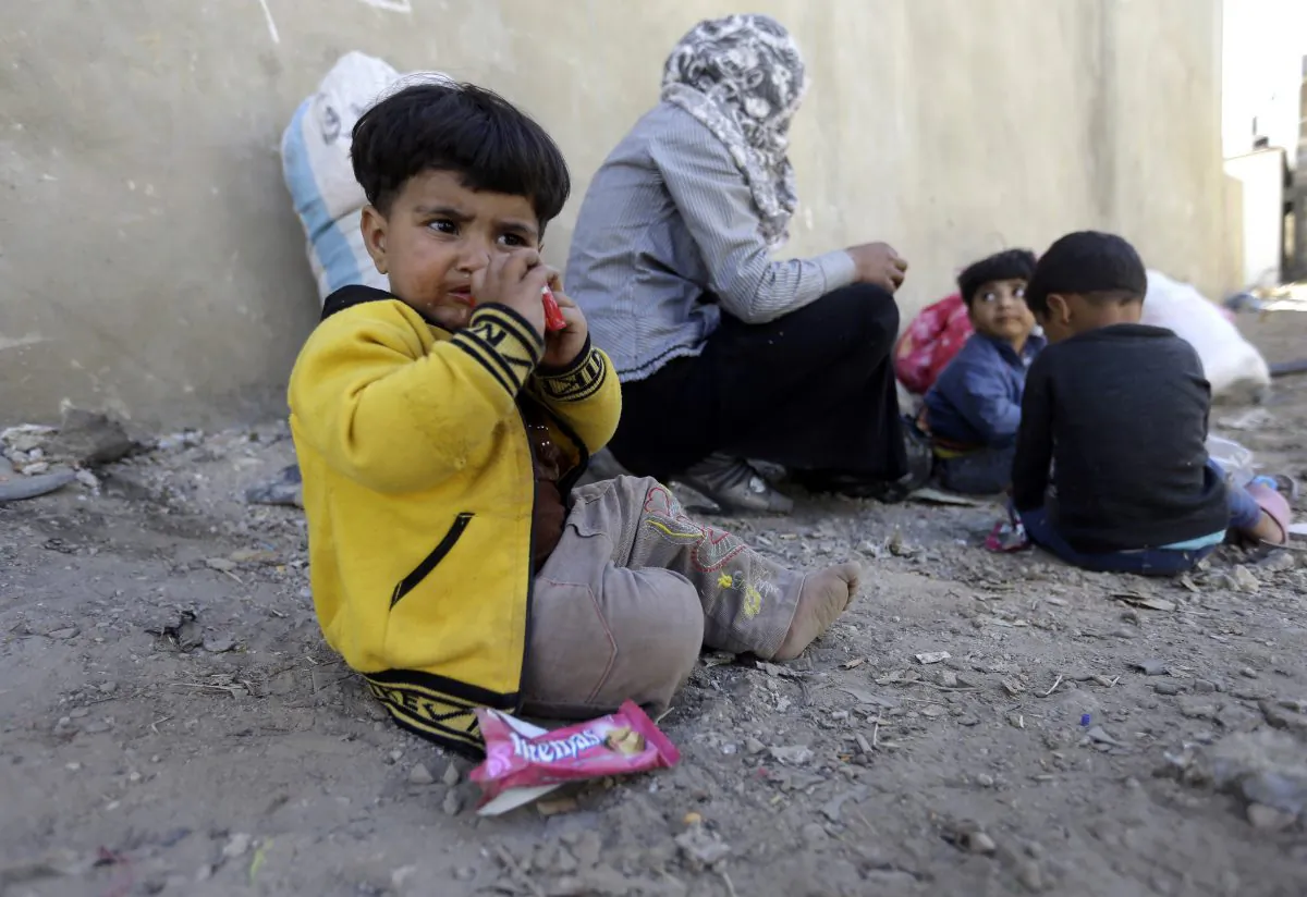 Raghad, 15 months, who fled to Lebanon this morning with her family from the Syrian town of Qusair after it fell in the hands of the Syrian forces loyal to President Bashar Assad and Hezbollah fighters, sits with her family in Arsal village, near the Lebanese-Syrian border, Wednesday, June 5, 2013. The Syrian army captured a strategic town near the Lebanese border on Wednesday after a grueling three-week battle, handing a heavy defeat to rebels and solidifying a shift in the country's civil war in favor of President Bashar Assad's regime.(AP Photo/Hussein Malla)