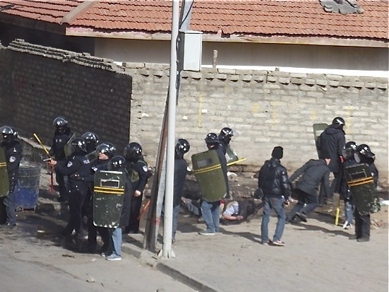 In a photograph from a partially Tibetan-inhabited area in China, police respond to a protest in Serta town, Sichuan Province, on Jan. 24, 2012. The Chinese Communist Party has embarked on a new campaign of political mobilization, indoctrination, and surveillance, according to Party documents and Human Rights Watch. (Students for a Free Tibet)