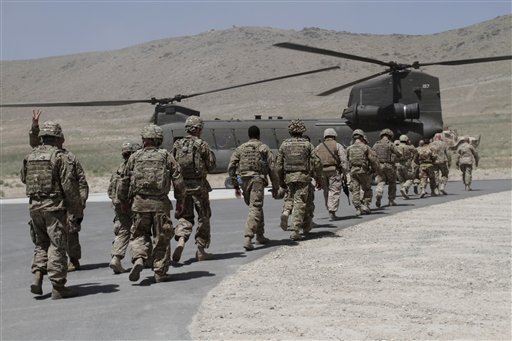 NATO solders walk towards a Chinook helicopter after a ceremony at a military academy on the outskirts of Kabul, Afghanistan, Tuesday, June 18, 2013. (AP Photo/Rahmat Gul)