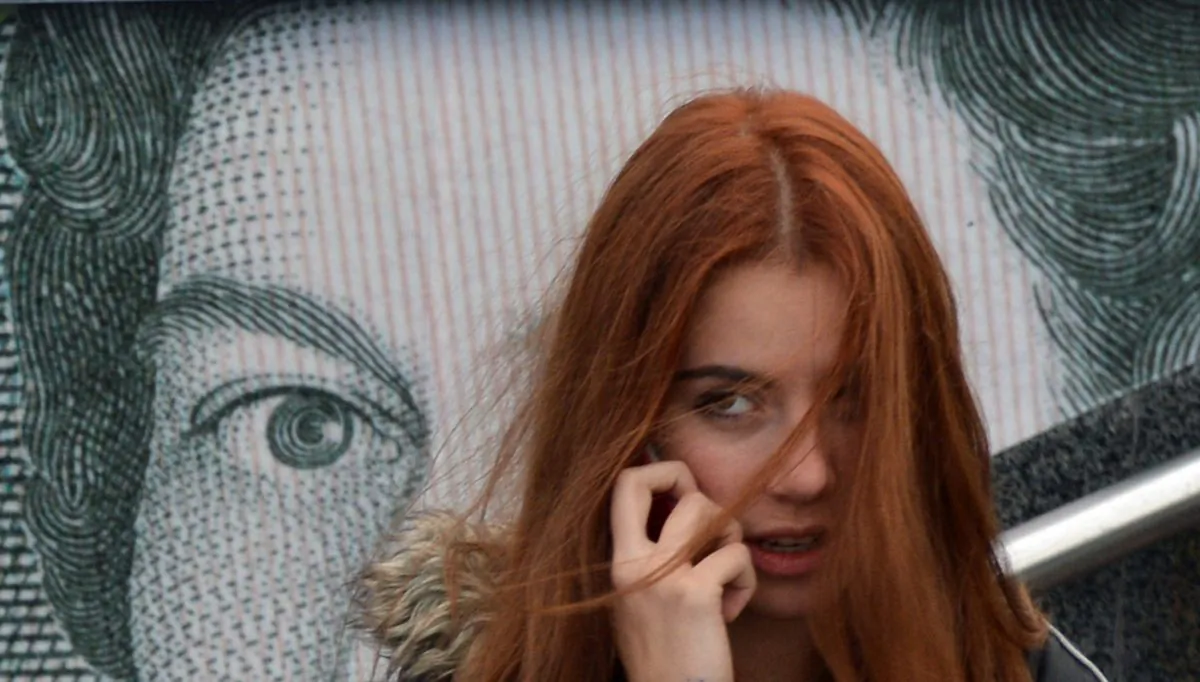 A girl speaks on a mobile phone in Kyiv, Ukraine, on Nov. 12, 2012. Addressing e-waste, including used mobile phones, is on Ukraine's list of ecological changes to make—119th on the list, with no funding plan. But an EU agreement may change that. (Sergei Supinsky/AFP/Getty Images)