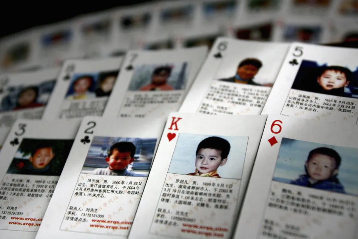 Playing cards showing details of missing children are displayed in 2007 in Beijing, China. The cards were created by Shen Hao, the founder of a missing persons website, and are handed out in areas notorious for child trafficking. China is on a list of countries with serious concern for human trafficking. (China Photos/Getty Images)