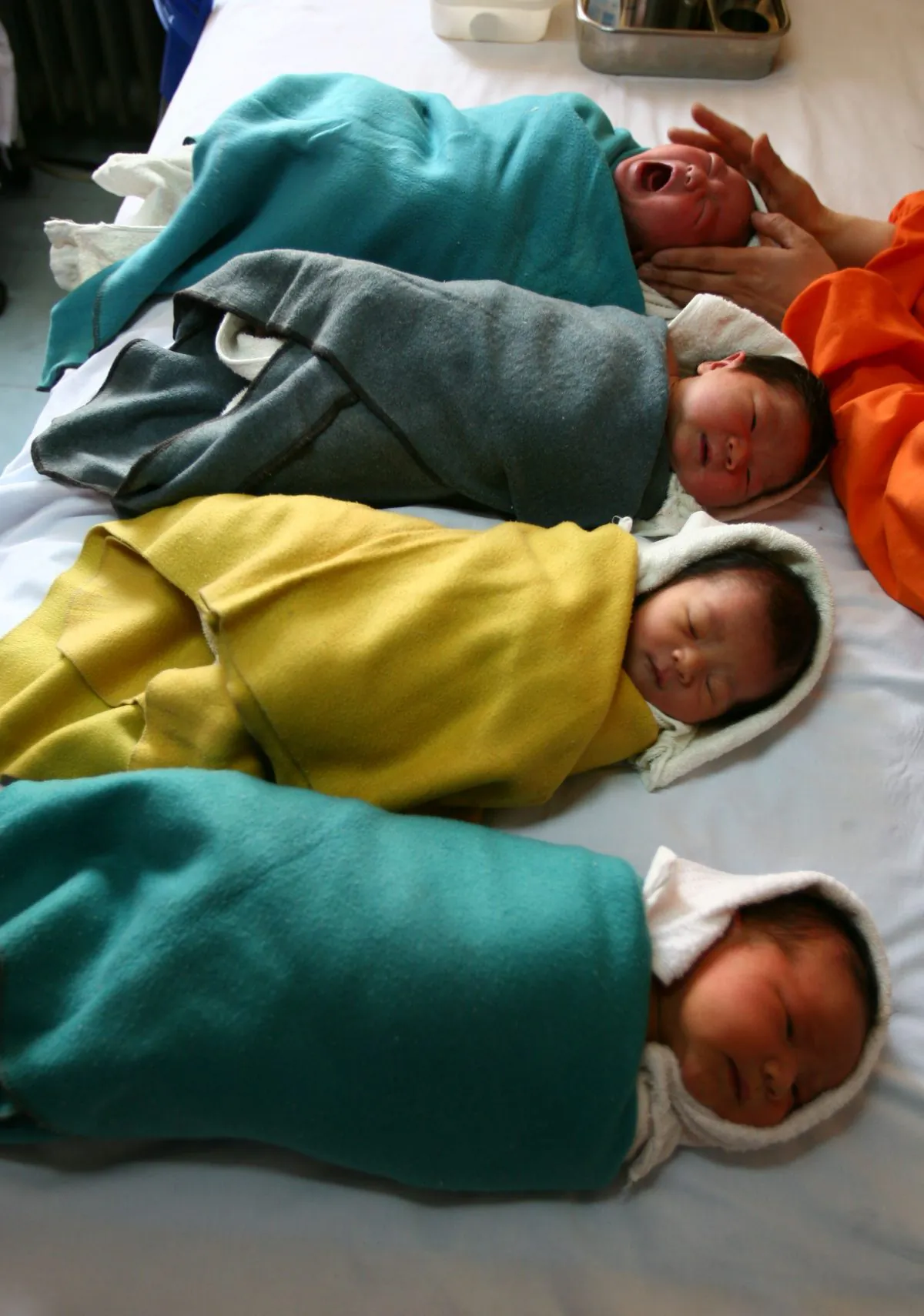 A nurse comforts a baby at the Xining Children Hospital in Xining City, Qinghai Province. Hospitals in Henan Province have been advertising the selling of unwanted babies, according to a report by China National Radio. (Getty Images) 