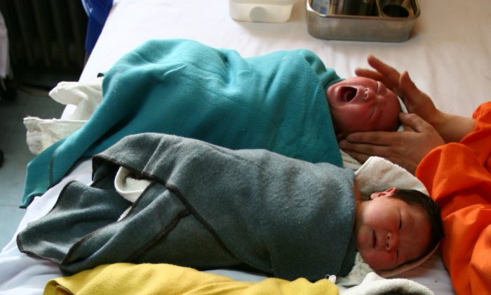 A nurse comforts a baby at the Xining Children Hospital in Xining City, Qinghai Province. Hospitals in Henan Province have been advertising the selling of unwanted babies, according to a report by China National Radio. (Getty Images) 